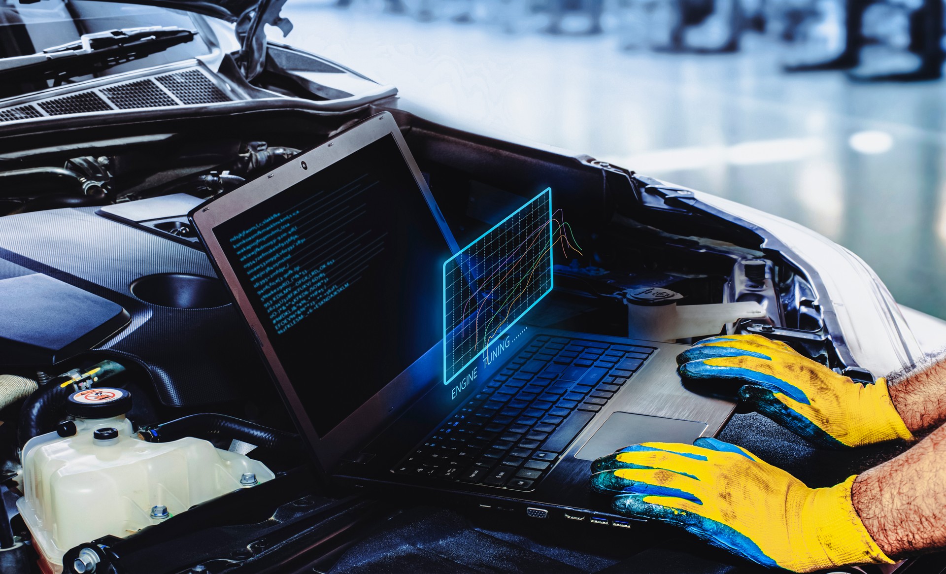 Technician is tuning engine car with a computer software of the laptop